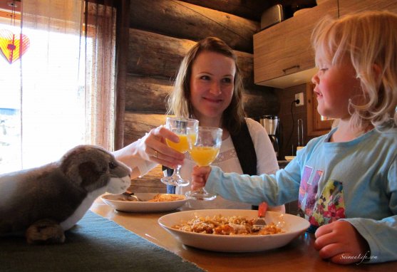 Mom and daughter eating beside cottage table