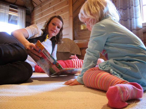 Mom and daughter playing on cottage floor