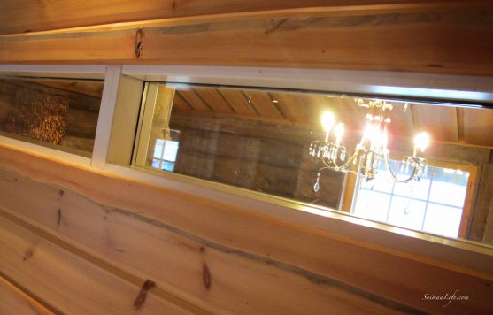 Small window and chandelier in cottage