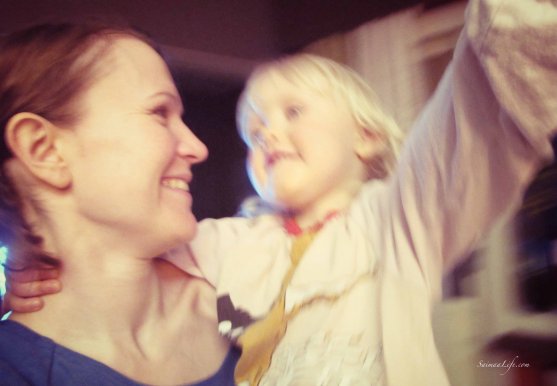 Mother and daughter are dancing happily laughing