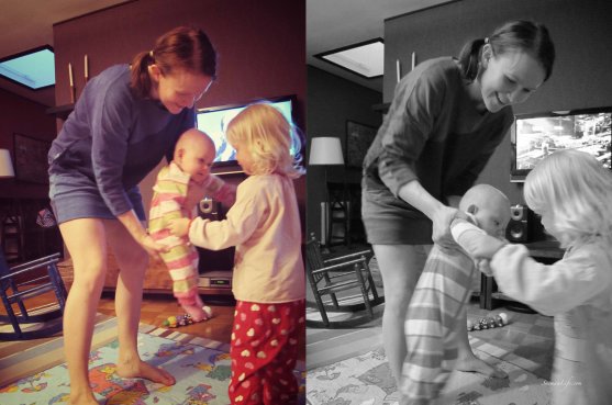 Mother and daughter are dancing infront of tv screen