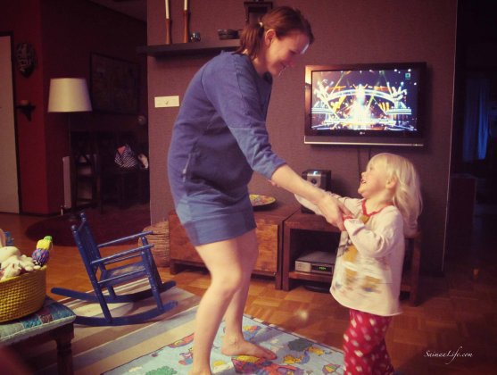 Mother and daughter dancing while voice of finland airs background