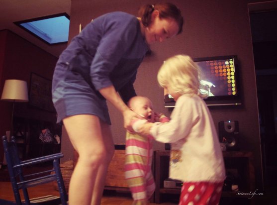 Mother and two daughters dancing