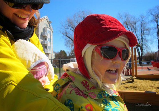 baby daughter and mom playing at playground