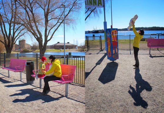 mom and daughter sitting on playground bench and playing