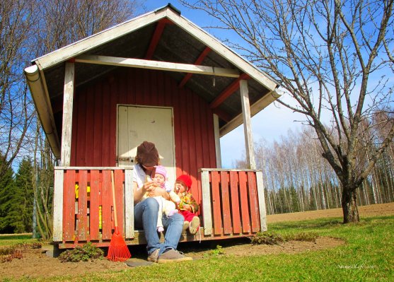 mom and two daughters eating ice cream on the playhouse porch