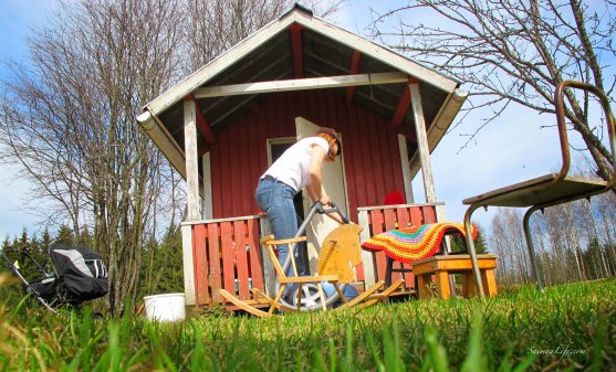 woman cleaning playhouse porch during spring