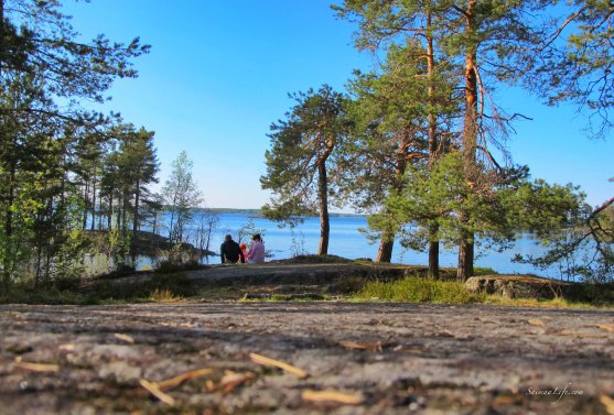 family-sitting-together-by-the-lake