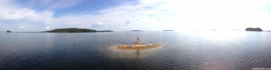 woman-practising-yoga-on-lake-puruvesi-in-savonlinna-finland