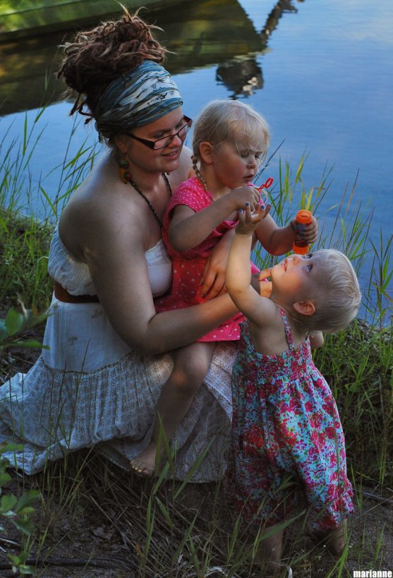 child-blowing-soap-bubbles-with-her-godparent