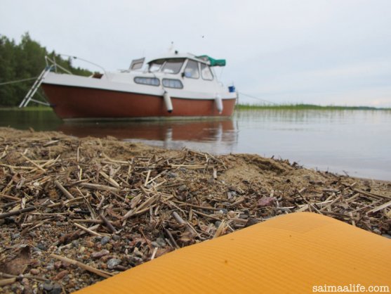 practising-yoga-by-lake-next-to-boat