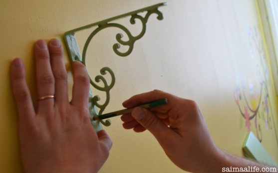 father-is-putting-up-book-shelves-to-children-room