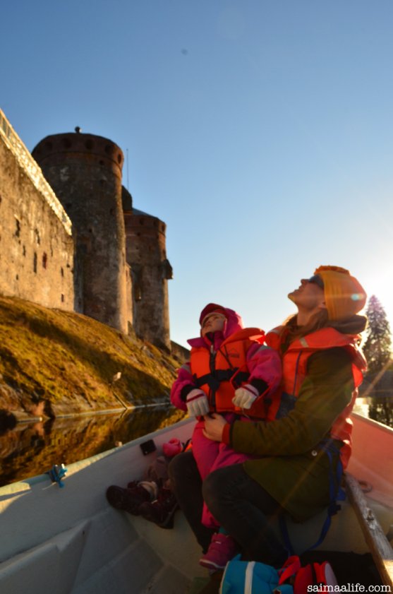 mother-and-child-on-boat-next-to-olavinlinna-castle-in-finland
