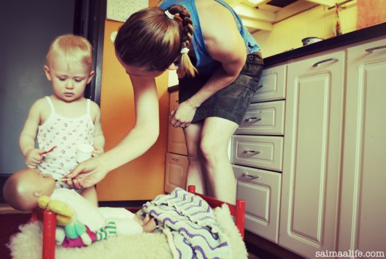 working-mom-cooking-and-playing-with-child-at-the-same-time