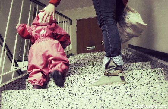 child-learning-to-go-stairs-with-her-mom