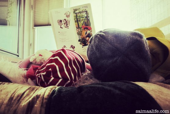 mom-reading-book-to-child-on-balcony