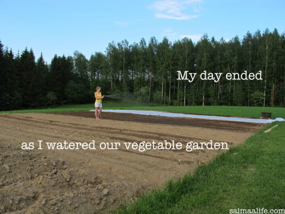 mother-watering-vegetable-garden-in-the-evening