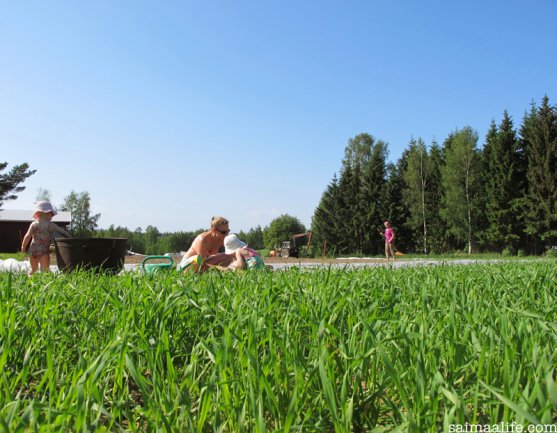 three-generations-planting-vegetable-garden-together