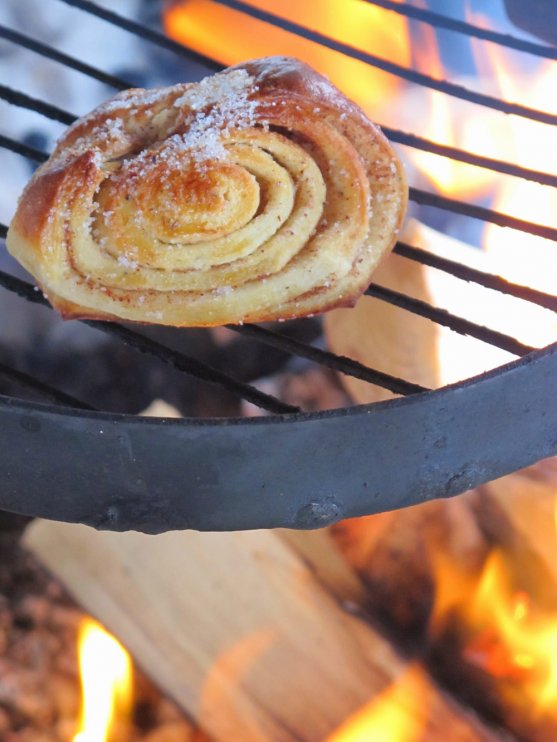 cinnamon-roll-warming-up-on-fireplace