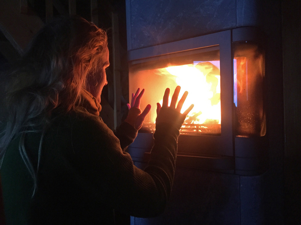 woman-thinking-by-the-fireplace