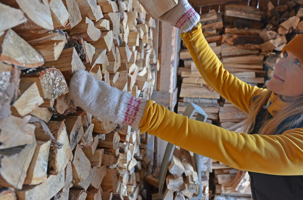 slower-rhythm-woman-taking-firewood