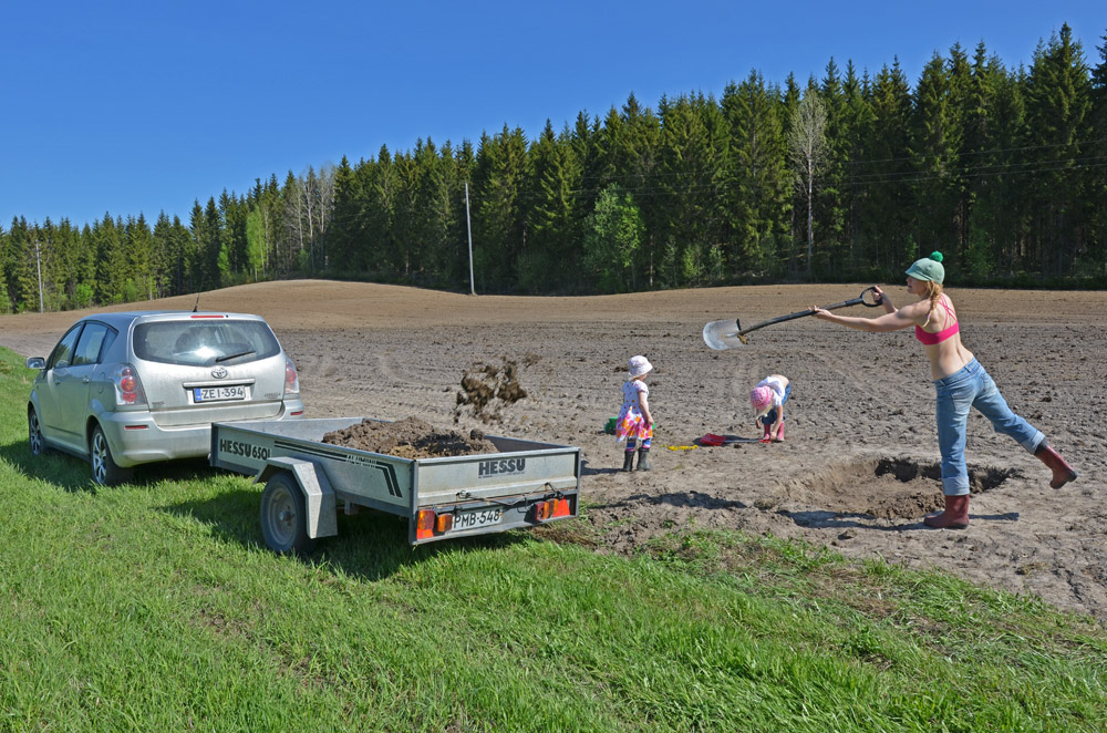 woman-shoveling-soil-in-field