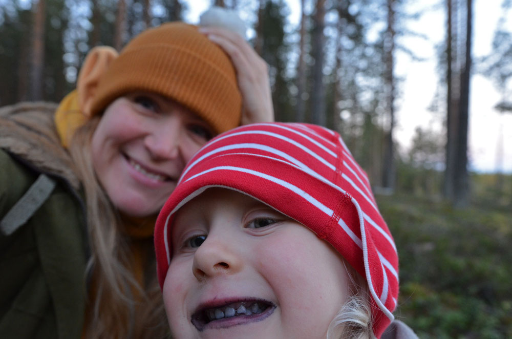 mother-and-child-eating-berries-together-in-forest