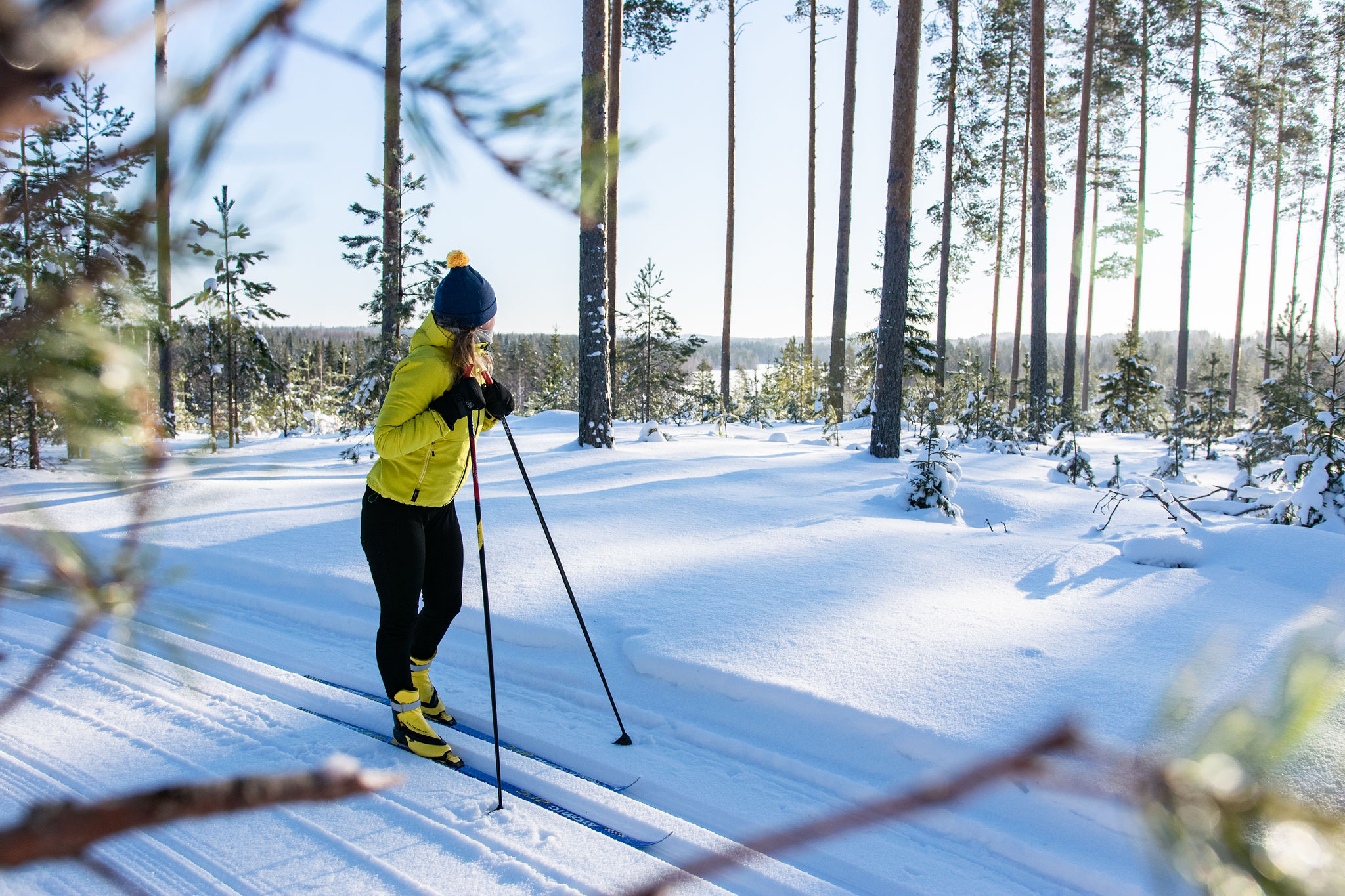 SaimaaLife Mari doing cross country skiing at Lomalehto cottages winter forests