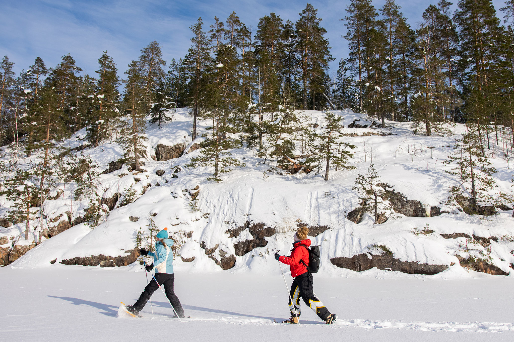 Winter snowshoeing on lake at Lomalehto Cottages in Saimaa, Finland