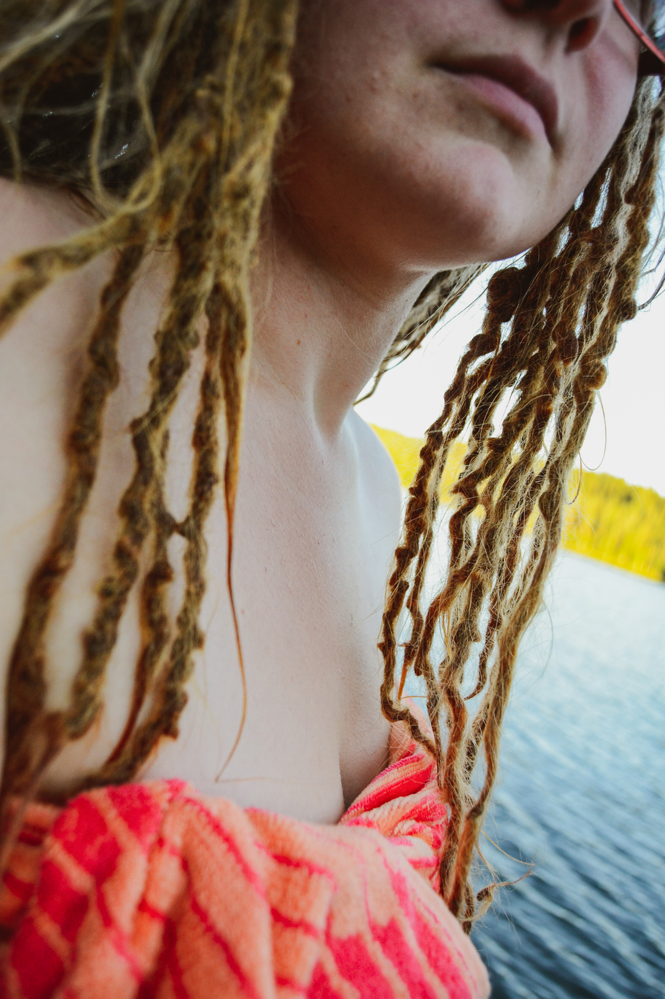Finish woman with dreadlocks going to swim in the lake after sauna