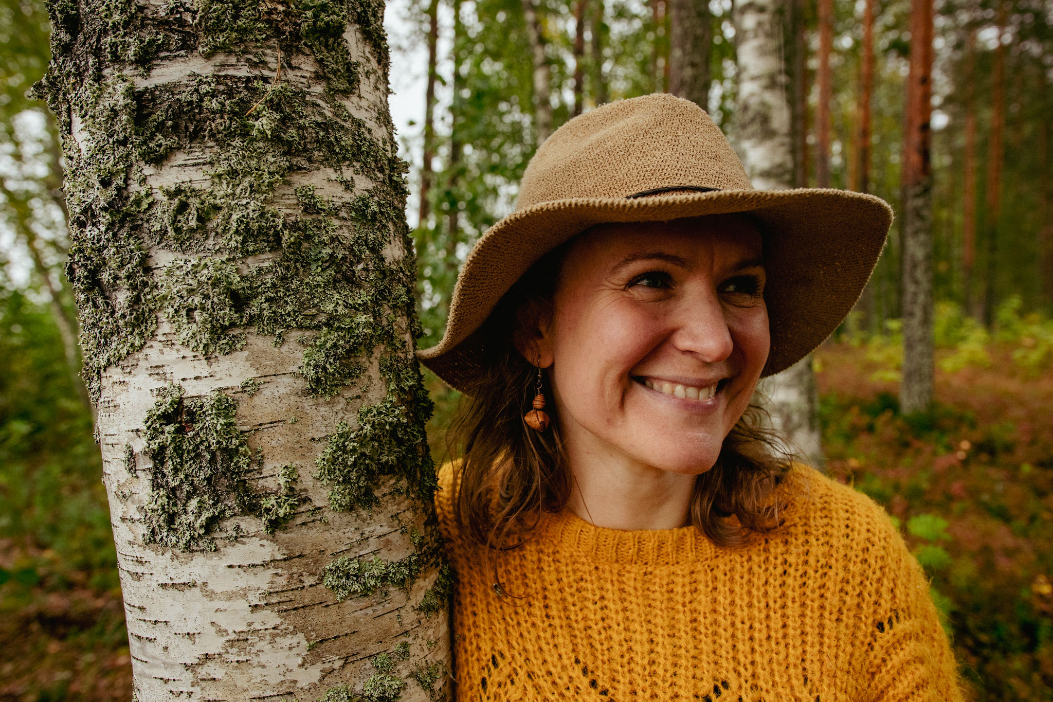 Mari saimaaLife with her birch bark earrings in nature