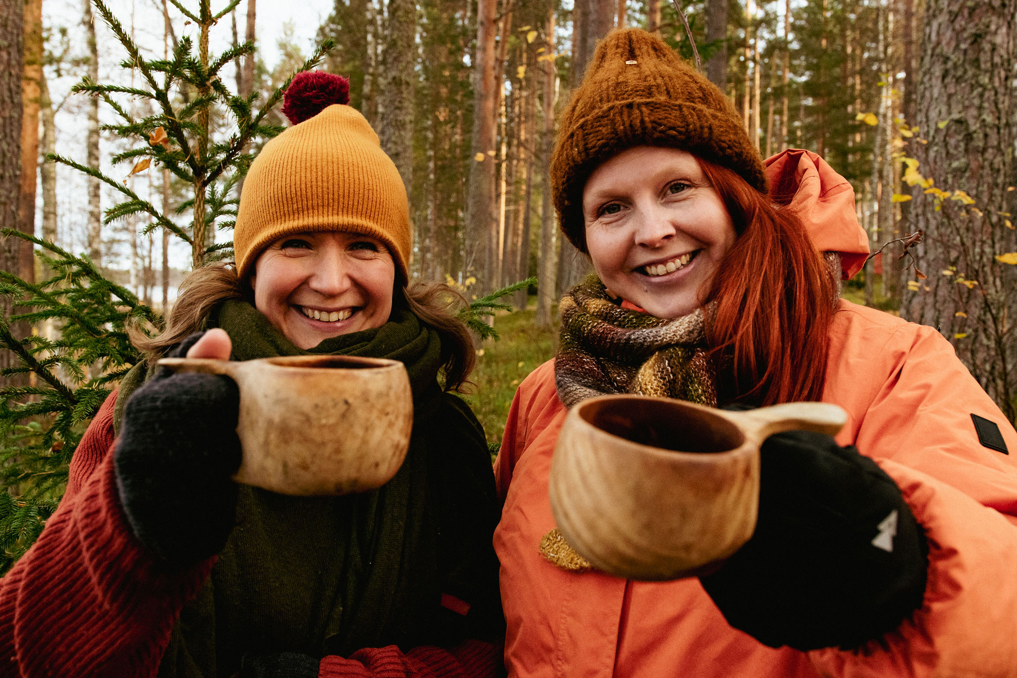 Mari and Stiina from saimaaLife with their wooden kuksa mugs in nature